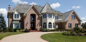 Large home in suburbs with turret and arched entry
